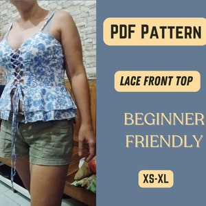 May include: PDF pattern for a lace front top. The pattern is beginner friendly and includes sizes XS-XL. The image shows a woman wearing a blue and white floral top with a lace-up front.