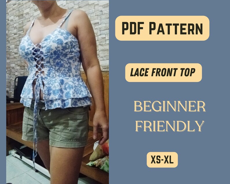 May include: PDF pattern for a lace front top. The pattern is beginner friendly and includes sizes XS-XL. The image shows a woman wearing a blue and white floral top with a lace-up front.