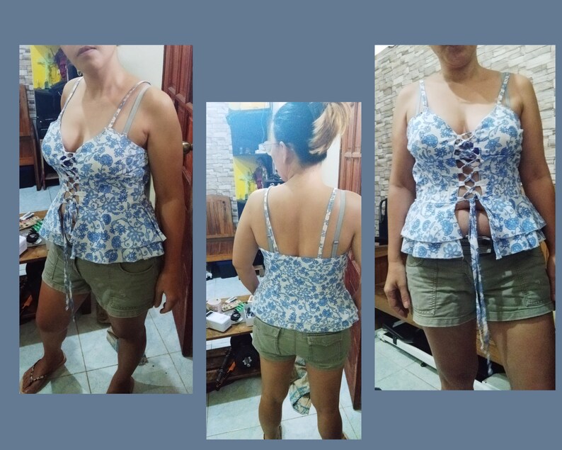 May include: A blue and white floral print top with a lace-up front and a ruffled hem. The top is worn with khaki shorts.
