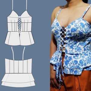 May include: A white and blue floral print top with a lace-up front and a ruffled bottom. The top has thin straps and a sweetheart neckline.