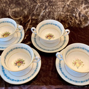 Set of four Wedgwood bone china footed cream soup bowls and saucers