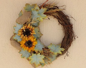 This beautiful 24” twig wreath is highlighted with vintage sunflowers. It’s vintage look will complement any room in your home.