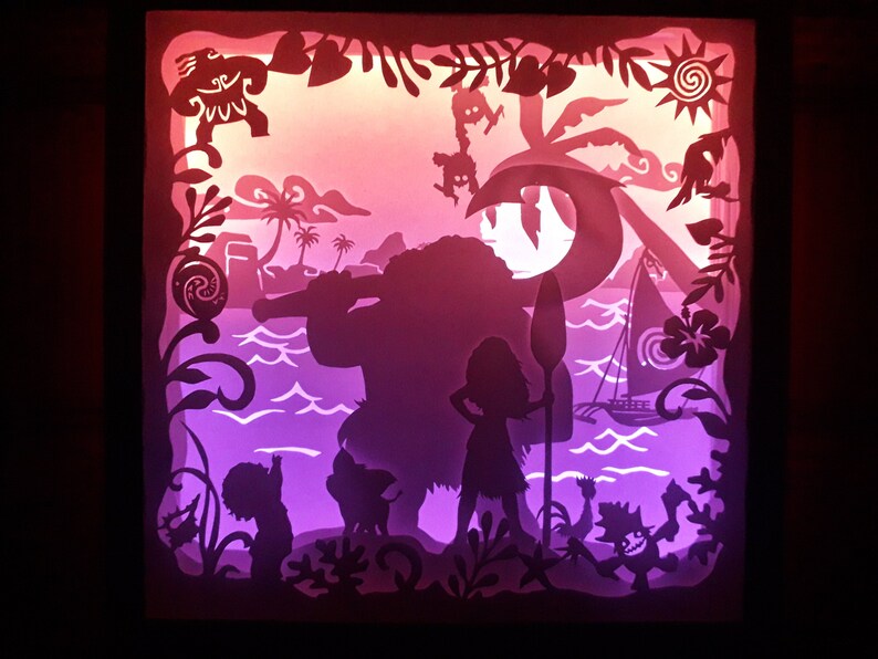 May include: A layered paper art piece depicting a tropical island scene with silhouettes of characters, palm trees, and a sailboat. The artwork features a gradient of pink, purple, and orange hues, creating a vibrant and dynamic composition. The piece is framed in a dark border.