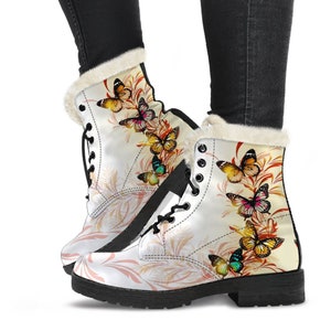 May include: White leather boots with a black sole and a faux fur lining. The boots feature a colorful butterfly pattern with a floral background.