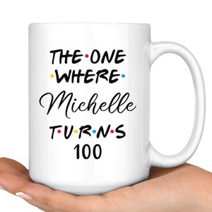 May include: White ceramic mug with black text that reads "The One Where Michelle Turns 100". The text is styled to look like the Friends logo.