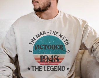 May include: A white sweatshirt with a vintage-style graphic that reads "The Man * The Myth * October 1943 * The Legend".