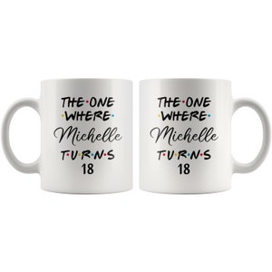 May include: Two white coffee mugs with black text that reads "The One Where Michelle Turns 18". The text is decorated with colorful dots.