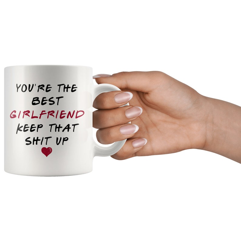 May include: White ceramic mug with black text that reads "You're the best girlfriend keep that shit up" with a red heart.
