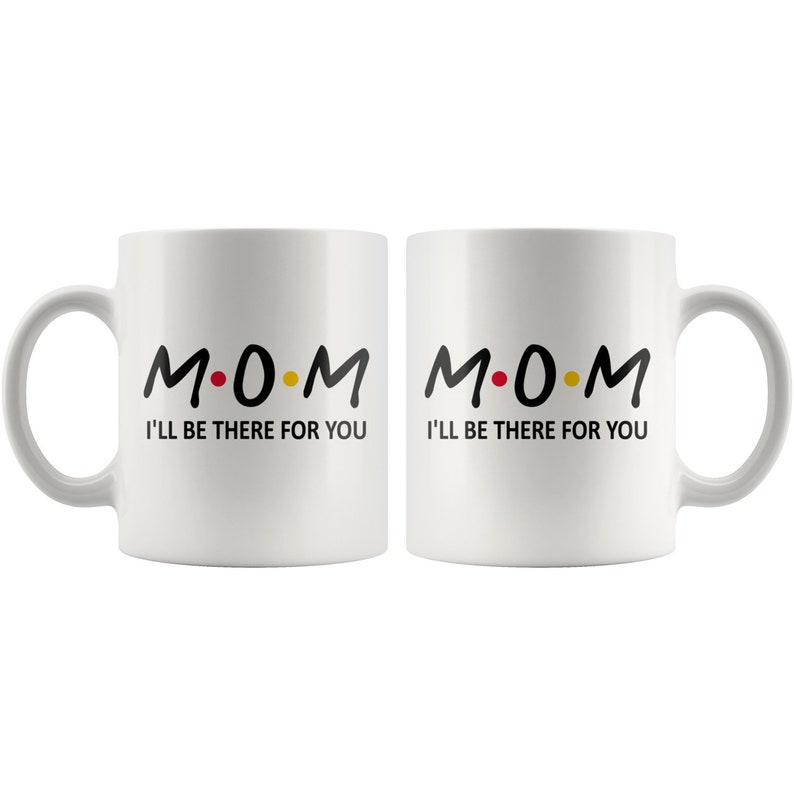 May include: Two white ceramic mugs with black text that reads "M.O.M. I'll be there for you".