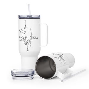 May include: White insulated tumbler with a handle, straw, and lid. The tumbler features a black line drawing of hands holding each other, with names above each hand. The names are Mamie, Hugo, Lucie, and Sacha.
