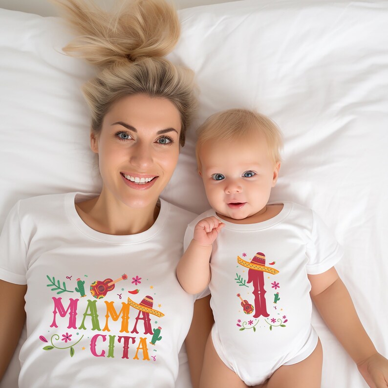 May include: A white t-shirt with the text "Mama Cita" in colourful letters and a sombrero, guitar, and cactus design. A white onesie with the text "1" in red and a sombrero, guitar, and cactus design.