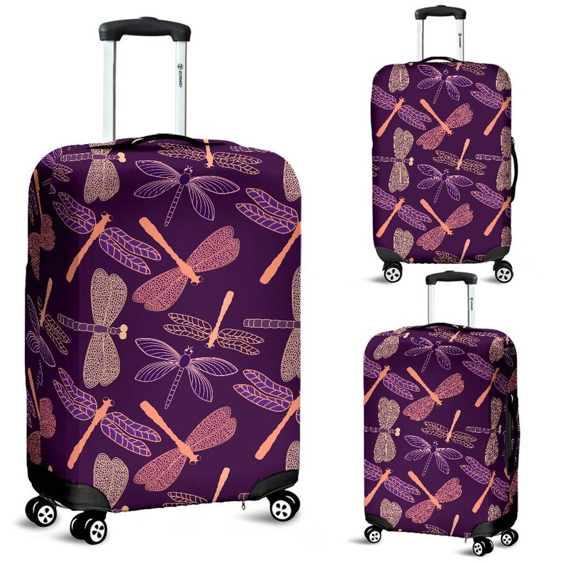 May include: Purple luggage cover with a pink dragonfly pattern. The cover is designed to fit a standard sized suitcase.
