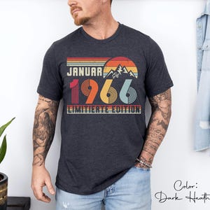May include: Dark heather gray t-shirt with a retro design. The graphic includes the text "JANUARY 1966" with a mountain and sunset illustration. The words "LIMITIERTE EDITION" are also printed on the shirt.