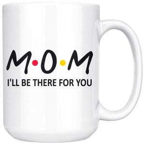 May include: White ceramic coffee mug with a black and yellow design that says "M.O.M. I'll be there for you".