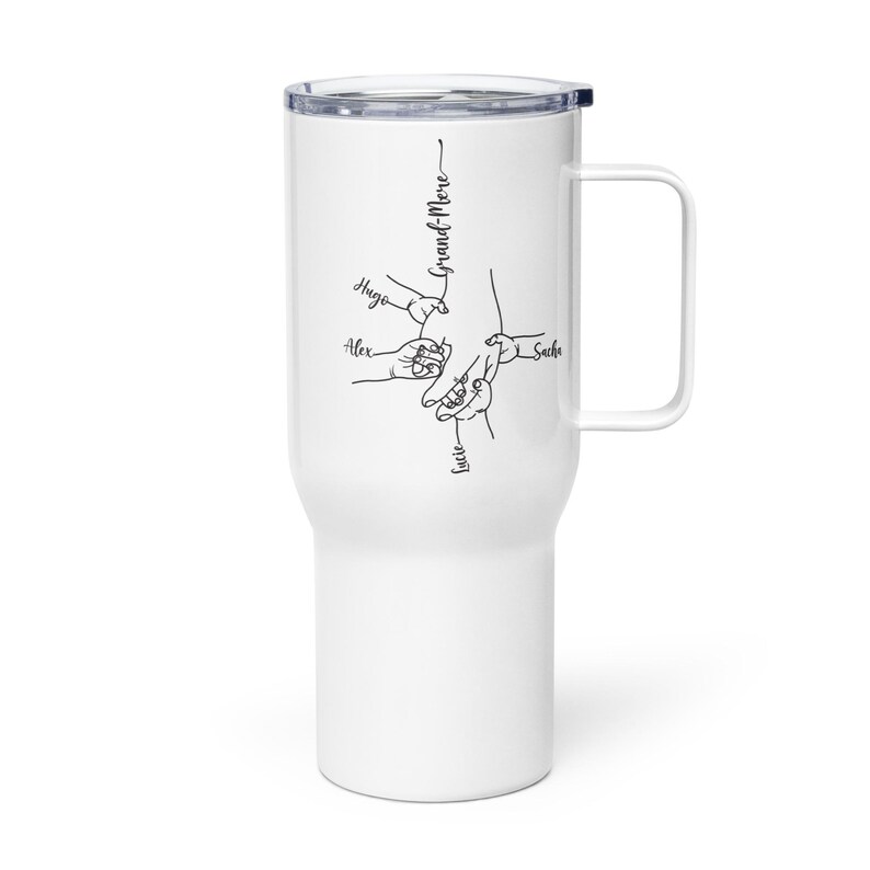 May include: White travel mug with a handle and a black lid. The mug features a black line drawing of hands holding each other, with the names Hugo, Alex, Lucie, and Sacha. The word "Grand-M&egrave;re" is also written on the mug.