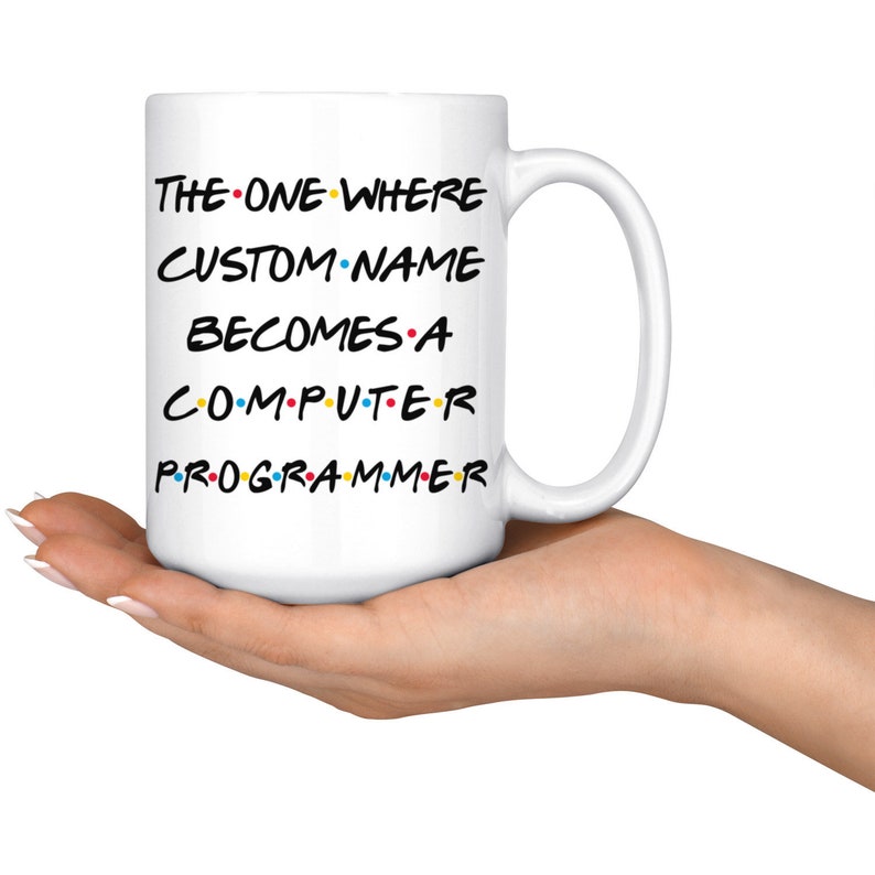 May include: White ceramic coffee mug with a black and white graphic that says "The One Where CUSTOM NAME Becomes A Computer Programmer" with colorful dots between the words.