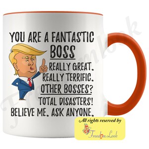 May include: White ceramic coffee mug with an orange rim and handle. The mug features a cartoon image of a man with a red tie and a black suit. The text on the mug reads "You are a fantastic boss. Really great. Really terrific. Other bosses? Total disasters! Believe me. Ask anyone."