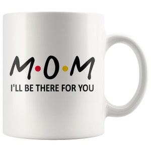 May include: White ceramic coffee mug with black text that reads "M.O.M. I'll be there for you".