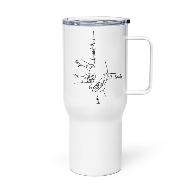 May include: White travel mug with a black illustration of hands and the words "Grand-P&egrave;re", "Hugo", "Alex", "Sacha", and "Lucie". The mug has a handle and a black lid.