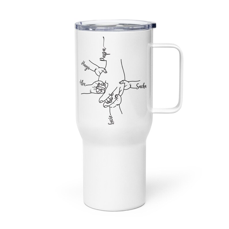 May include: White travel mug with a black line drawing of hands holding each other. The names "Hugo", "Alex", "Lucie", "Sacha", and "Papa" are written in black script. The mug has a handle and a black lid.