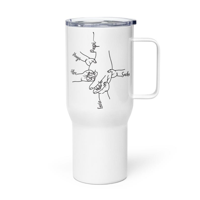 May include: White travel mug with a black line drawing of hands holding each other. The names "Hugo", "Alex", "Lucie", and "Sacha" are written near the hands. The word "Papi" is written above the hands.