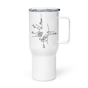 May include: White travel mug with a black illustration of hands holding each other, with the names "Hugo", "Alex", "Lucie", "Sacha", and "Mamie" written in black script. The mug has a handle and a black lid.