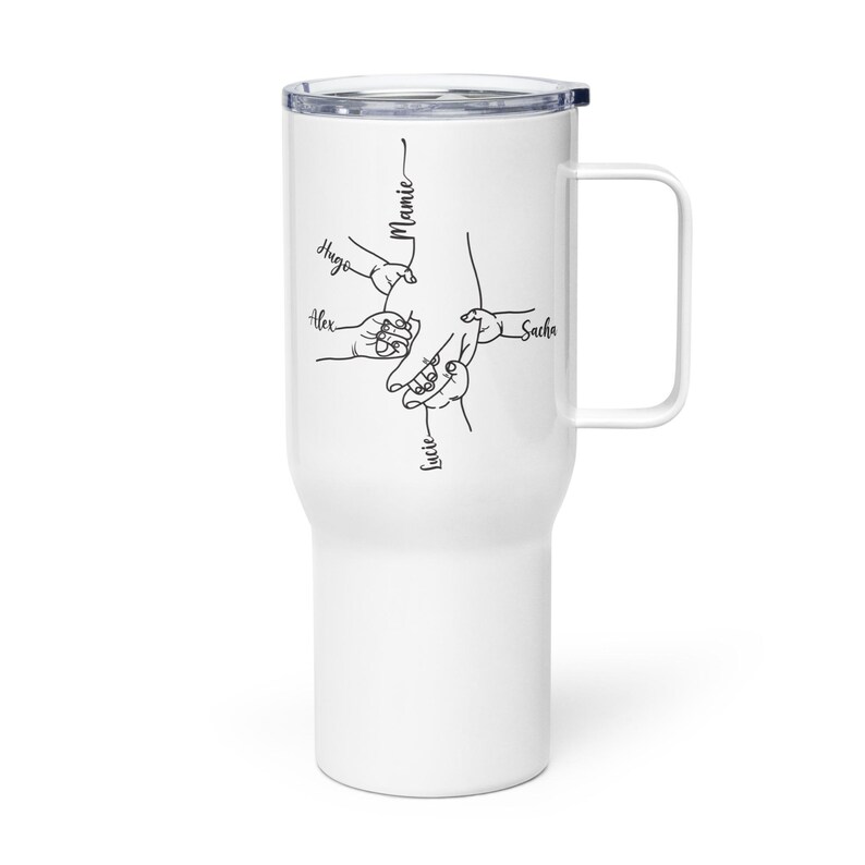 May include: White travel mug with a black illustration of hands holding each other, with the names "Hugo", "Alex", "Lucie", "Sacha", and "Mamie" written in black script. The mug has a handle and a black lid.