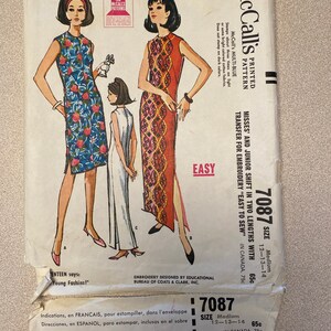 May include: A vintage McCall's sewing pattern for a shift dress in two lengths. The pattern is for misses and juniors, sizes 12-13-14. The pattern includes a transfer for embroidery. The pattern is easy to sew and is printed on a blue background with white text. The pattern is for a dress with a floral print and a solid color dress.