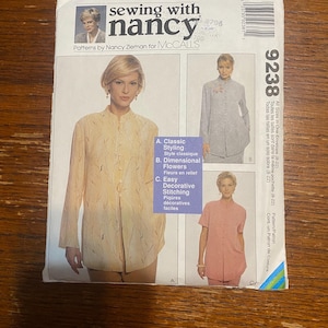 May include: Sewing pattern for a blouse with three different styling options: classic, dimensional flowers, and easy decorative stitching. The pattern is by Nancy Zieman for McCall's and is size 8-22.