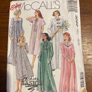 May include: A sewing pattern for a long robe with a tie at the neck. The pattern is for sizes petite to talle and includes five different styles. The pattern is from McCall's and is called "Fashion Basics".