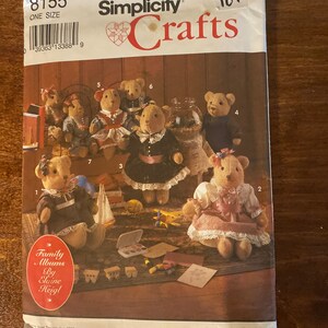May include: Simplicity Crafts pattern number 8155 for making a family of teddy bears. The pattern includes instructions for making seven bears in different outfits. The pattern is titled "Family Albums by Elaine Heigl".