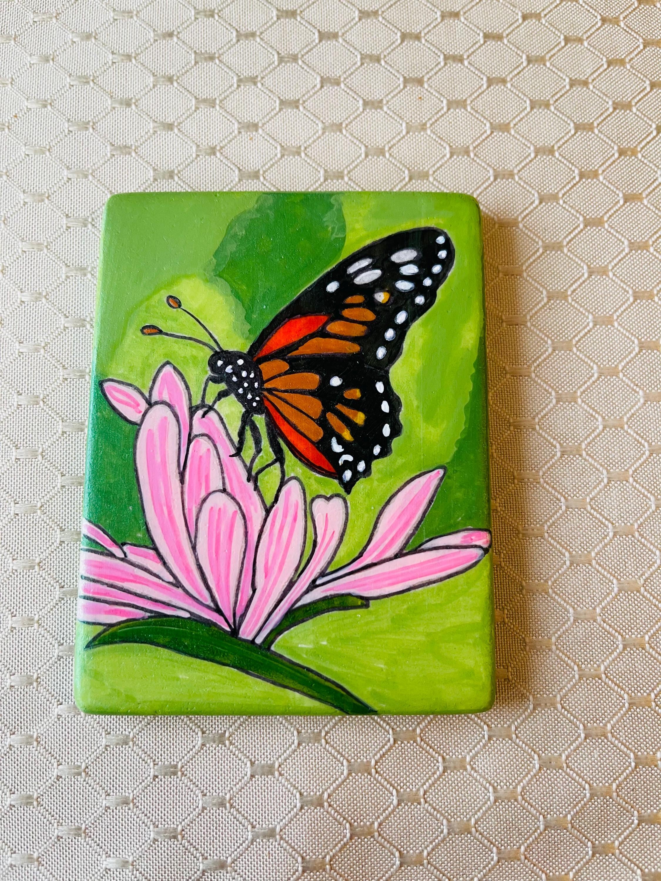 Monarch Butterfly painted rock SEALED among pastel pink flower