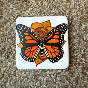 Monarch butterfly painted rock - on orange rose  SEALED
