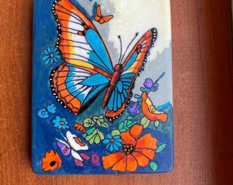 Butterfly Painted Rock SEALED among flowers on Santorini