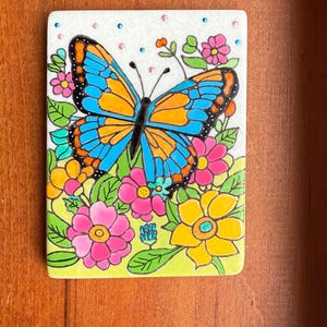 Butterfly Painted Rock SEALED among flowers