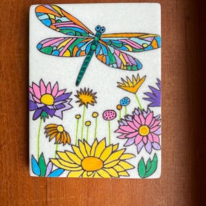 Dragonfly and flowers painted rock  SEALED