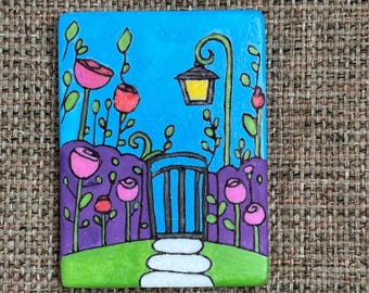 Whimsical garden gate hand painted rock SEALED