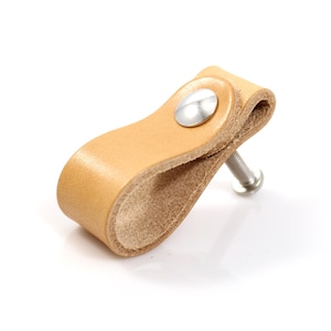 May include: A light brown leather cabinet pull with a silver screw and a silver round knob.
