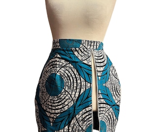 May include: A blue and white patterned skirt with a front slit. The skirt has a circular design with black outlines.