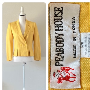 May include: A yellow linen blazer with a double breasted closure and a small label that reads "PEABODY HOUSE" and "MADE IN KOREA".