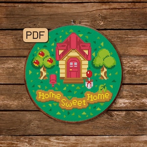 May include: Cross stitch pattern featuring a pixelated house, trees, and a mailbox with the text "Home Sweet Home". The pattern is in a green hoop with a PDF label.