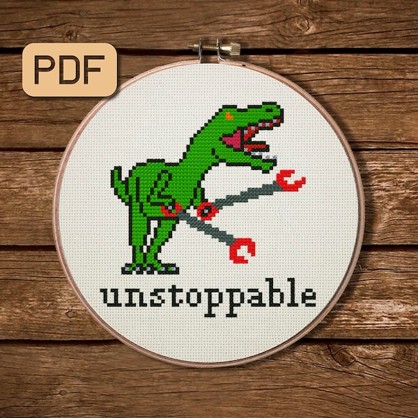May include: A cross-stitch pattern featuring a green dinosaur with red and gray arms, holding a wrench. The text "unstoppable" is below the dinosaur.