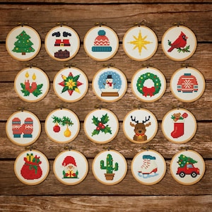 May include: Twenty cross-stitch embroidery hoops featuring festive Christmas designs. The designs include a Christmas tree, Santa Claus, a cardinal, a snowman, a wreath, and a red car carrying a Christmas tree.
