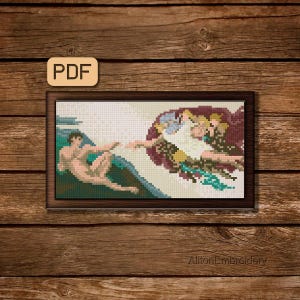 May include: A framed cross-stitch depicting Michelangelo's "The Creation of Adam" with a brown wooden frame. The artwork features figures in shades of beige, green, and burgundy. The text "PDF" is in the upper left corner. The text "AlltonEmbroidery" is in the lower right corner.