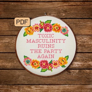 May include: A cross-stitch embroidery hoop with the text "TOXIC MASCULINITY RUINS THE PARTY AGAIN" in pink. The text is surrounded by a floral border with yellow, pink, and blue flowers. The PDF icon is in the upper left corner.