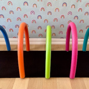 Pool Noodle anchors, Rainbow arch holders. Preschool, physical therapy, and occupational therapy ideas.
