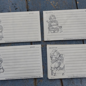 May include: Four blank recipe cards with a black and white illustration of a woman on each card. The cards have lines for writing down recipes and the text "RECIPE FOR" and "SERVES" at the top of each card.