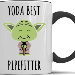 May include: White ceramic mug with a black handle. The mug features a cartoon image of Yoda from Star Wars, with the text "YODA BEST PIPEFITTER".