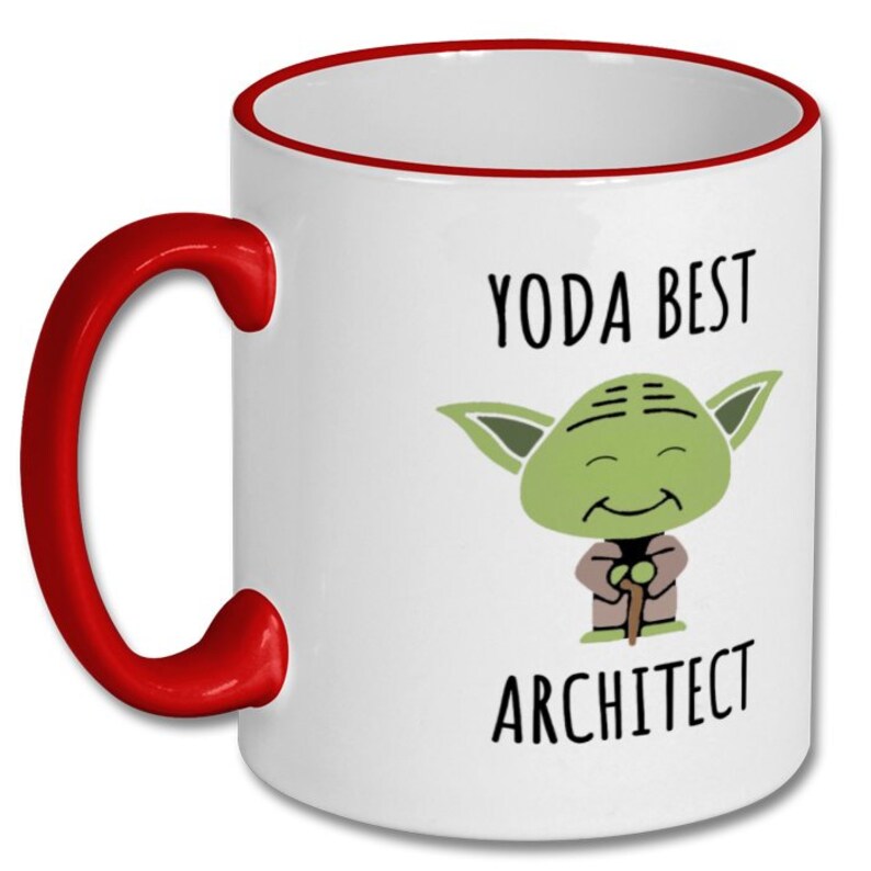 May include: White ceramic coffee mug with a red rim and handle. The mug features a cartoon image of Yoda from Star Wars with the text "Yoda Best Architect".
