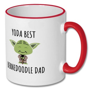 May include: White ceramic mug with a red rim and handle. The mug features a cartoon image of Yoda with the text "Yoda Best Bernedoodle Dad".